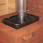 Metal stove lined with bricks in a steam room